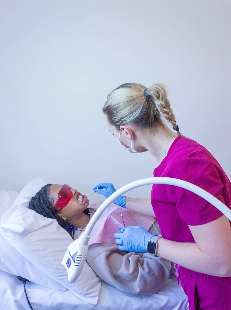Technician applying whitening gel during a session